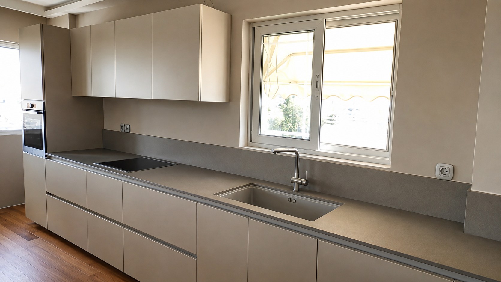 Caesarstone worktop and tall splashback with an undermount sink below the window — Chalandri
