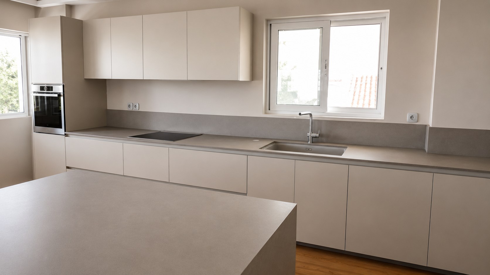 View of the kitchen over the island with its Caesarstone waterfall worktop — Chalandri