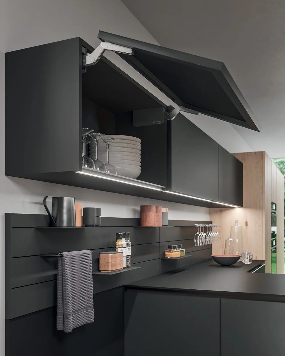 LED light built into the handle profile, under a lift-up wall unit
